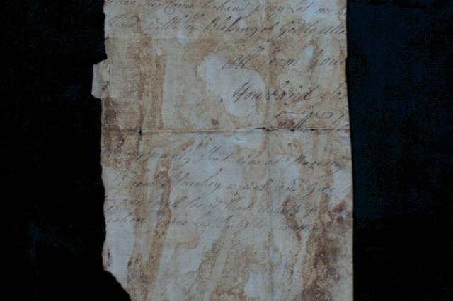 Fragment of pale parchment covered in handwriting in black ink