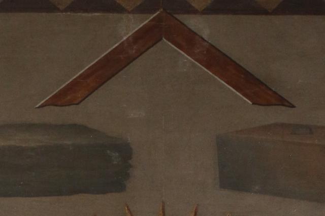 Brown stonemasons square above two grey stones, one rough and one smooth