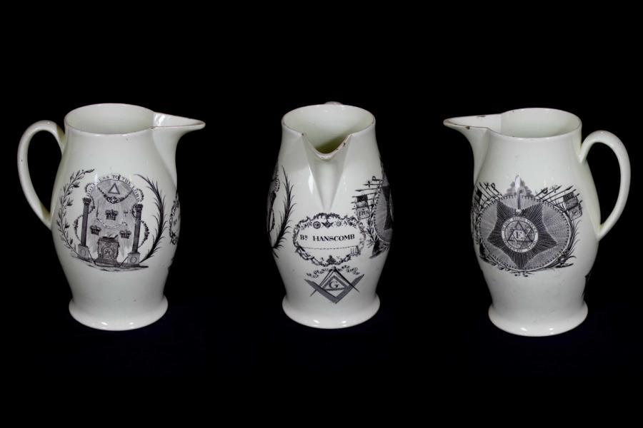 Left, front and right views of a white cream-ware jug with Royal Arch and Knight's Templarf printed decorations