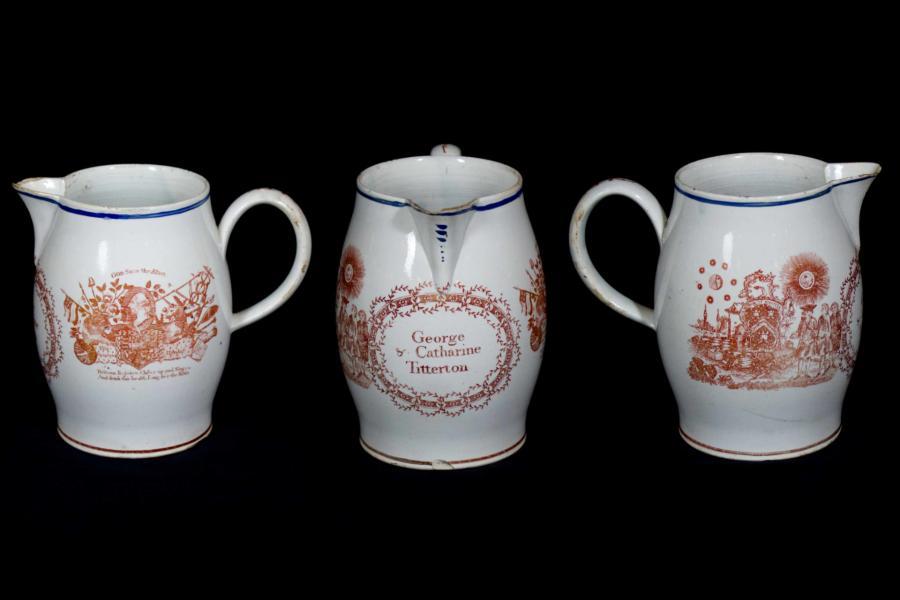 White jug with red designs featuring coats of arms and images in support of George III