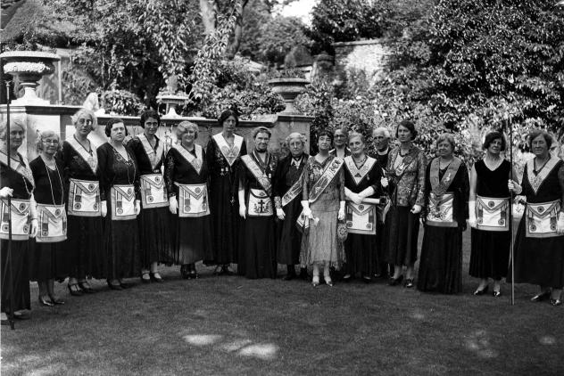 Group belonging to Freemasonry for Men and Women, showing a group of women (and one man) in regalia
